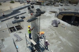 a group of men standing on top of a construction site